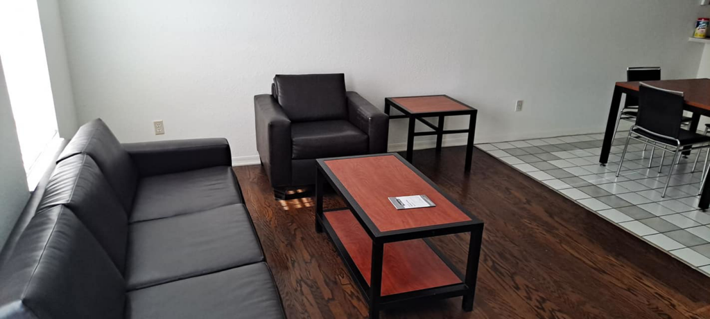 A tidy living room with clean hardwood floors and furniture, showcasing the results of Solid Rock Cleaning Company LLC's house cleaning in Orlando, FL