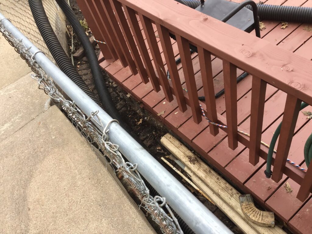 Tight space yard cleanup and debris removal by Lovett lawn care & snow removal in Omaha, NE.