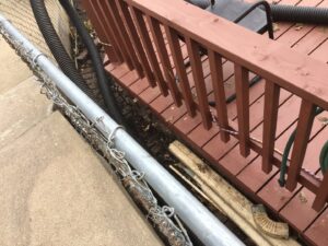 Tight space yard cleanup and debris removal by Lovett lawn care & snow removal in Omaha, NE.