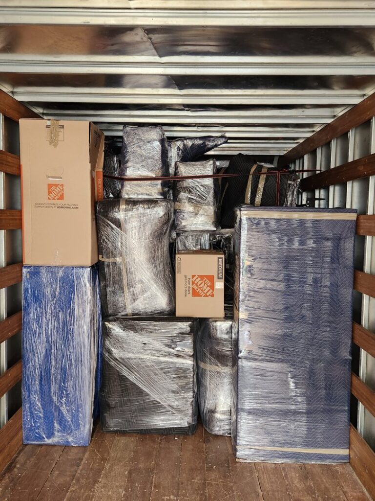 A moving truck interior tightly packed with wrapped furniture and boxes by Fatboy Slims Moving Company in Colorado Springs, CO.