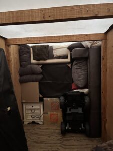 The interior of a moving truck tightly packed with furniture, pillows, and boxes by E.L.I Movers LLC in Houston, TX.