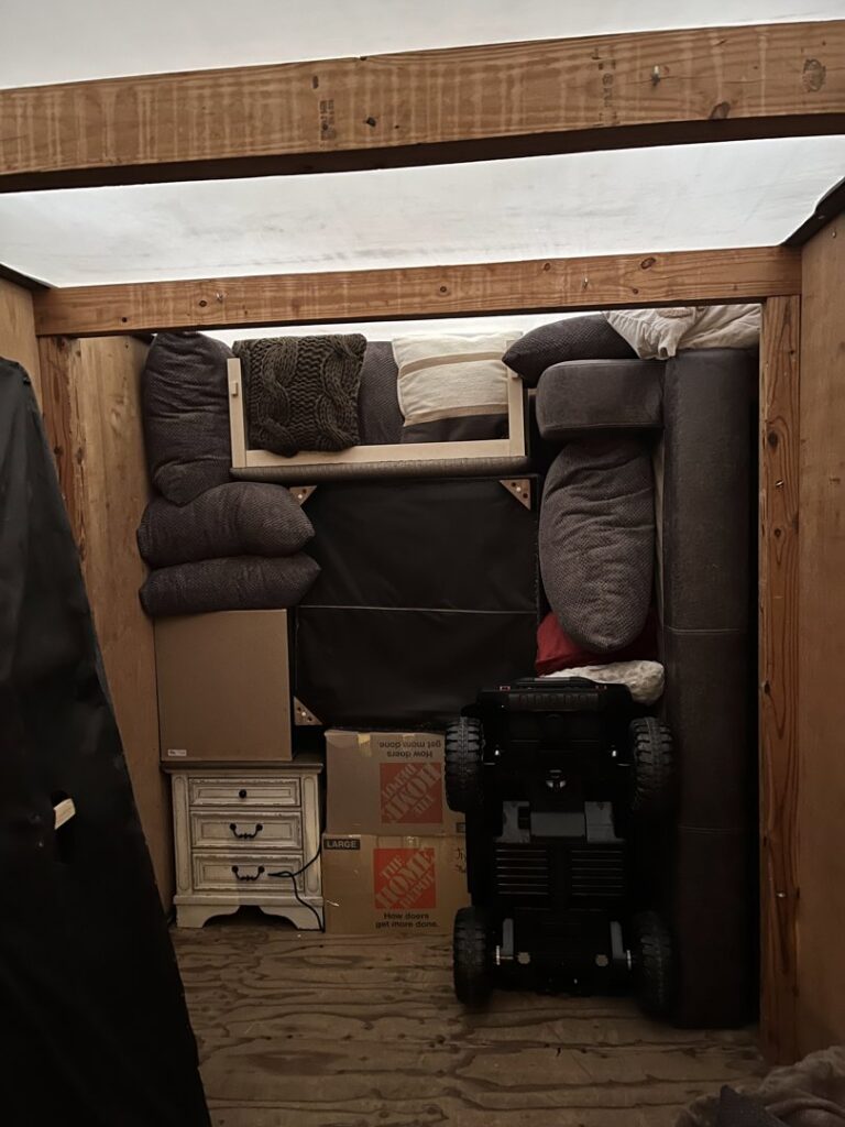 The interior of a moving truck tightly packed with furniture, pillows, and boxes by E.L.I Movers LLC in Houston, TX.