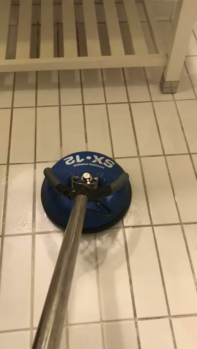 A professional hard surface cleaning machine restoring a white tiled floor after water damage by Renue Systems Of Oahu in Honolulu, HI