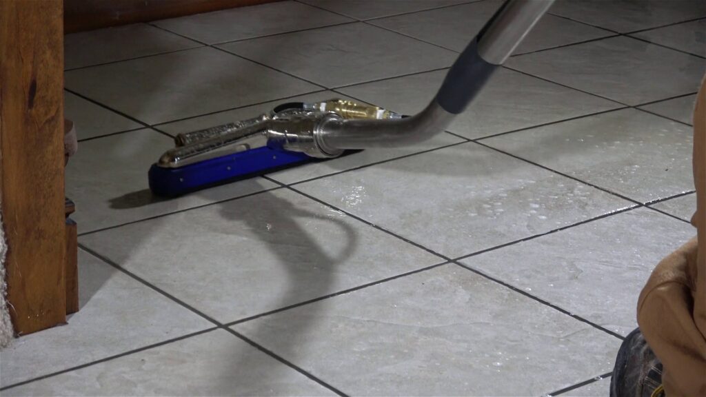 A professional tile and grout cleaning tool in use on a kitchen floor by Pile's Carpet Care & Restoration Service in Elizabethtown, KY.