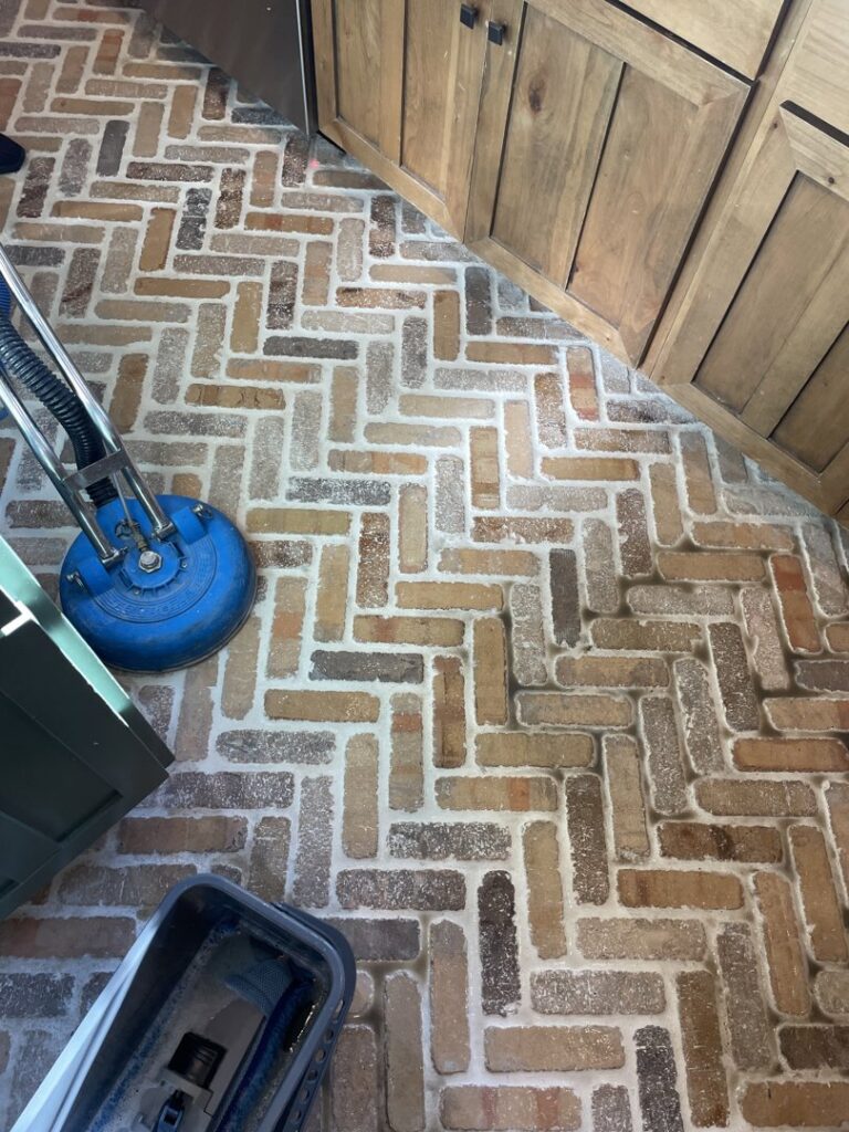 A house cleaner from Idaho Gem Cleaning performing professional tile and grout floor cleaning in Caldwell, ID.
