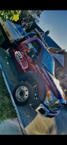 A Citywide Towing Services flatbed truck with a vehicle partially loaded on its bed in Dearborn, MI.