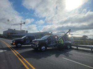 A Bobbys Towing & Recovery operator assisting a vehicle with a wrecker tow truck in Raleigh, NC.