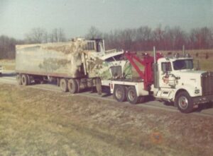 An old photo of a Bevis Towing truck towing a damaged semi-trailer in Cincinnati, OH.