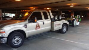 An A-Tow Atlanta / Alpharetta tow truck towing a green Polaris Slingshot in Atlanta, GA.