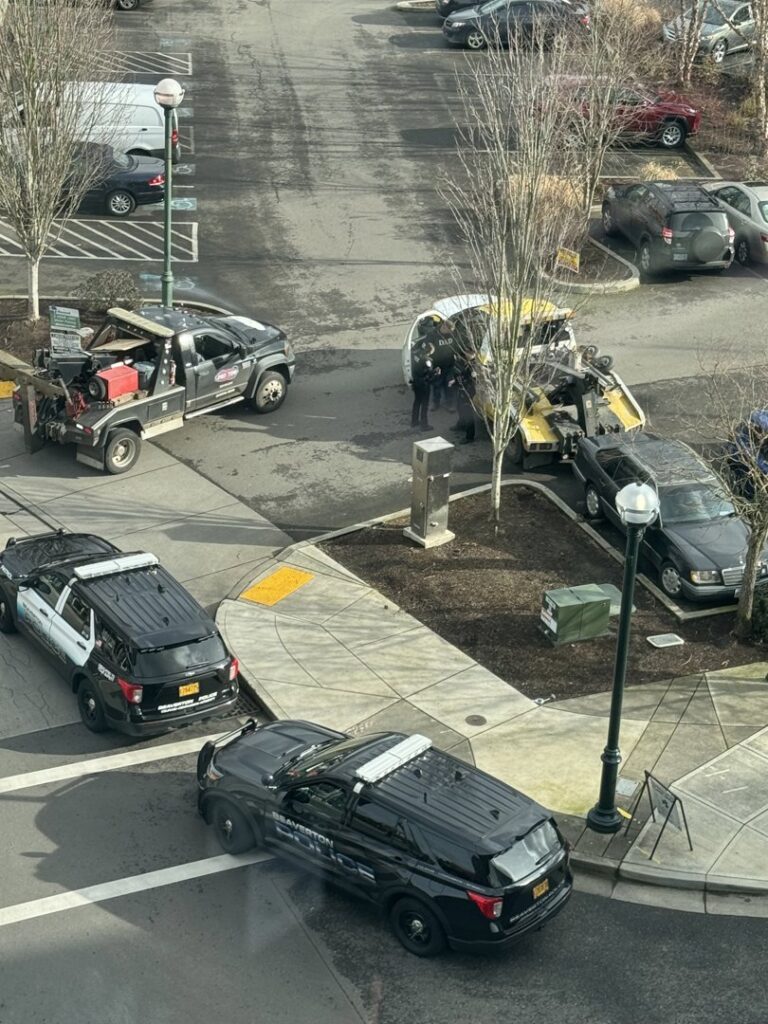 PRO TOW tow trucks and police at a vehicle recovery operation in Beaverton, OR.