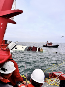 TowBoatUS San Diego crew assisting a partially submerged boat during a rescue operation in San Diego, CA.