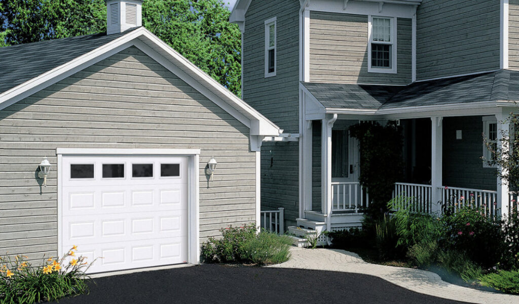 A traditional home with a classic white garage door, a service offered by Sawtooth Garage Doors in Boise, ID.