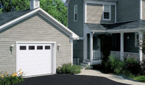 A traditional home with a classic white garage door, a service offered by Sawtooth Garage Doors in Boise, ID.