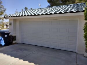 A traditional white paneled garage door installed on a home by Cactus Garage Doors, Inc. in North Las Vegas, NV.