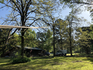 A residential property with a bucket truck and ropes set up for tree service by Munoz Tree & Lawn Service in Little Rock, AR.