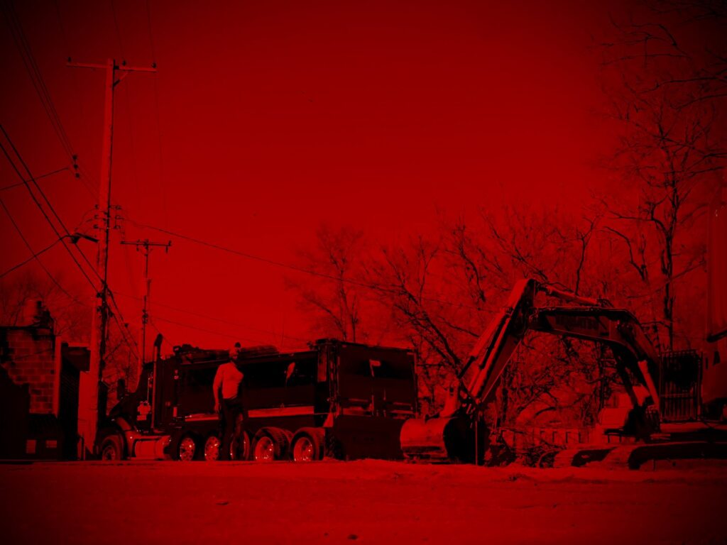 A truck with a snow plow and an excavator ready for snow removal services by Bladecutters Demolition, Snow Removal, Landscaping & Lawn in Dayton, OH.