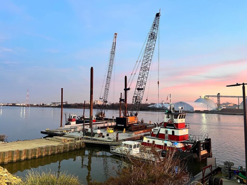 Myrick Marine Contracting Corp.'s fleet of tugboats and crane barges docked at a pier in Norfolk, VA.
