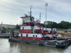 The tugboat Grace Myrick docked at a pier, showcasing Myrick Marine Contracting Corp.'s fleet in Norfolk, VA.