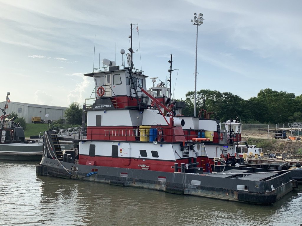 The tugboat Grace Myrick docked at a pier, showcasing Myrick Marine Contracting Corp.'s fleet in Norfolk, VA.