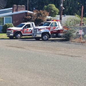 Two Al's Towing trucks, a flatbed and a wrecker, parked side-by-side in Jackson, NJ