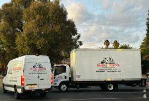 Two branded moving vehicles, a cargo van and a box truck, from Trustee Logistics LLC in Springfield, IL.