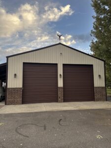 Two newly installed brown commercial garage doors on a building, completed by Right Choice Doors in Layton, UT.