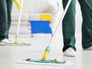 Two professional cleaners mopping a residential floor, demonstrating services by CPIA Cleaning Services in Des Moines, IA