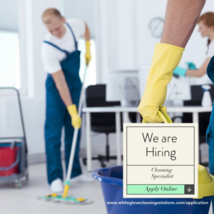 Two professional cleaners, one mopping and one wiping, performing cleaning services for White Glove Cleaning Solutions in Akron, OH
