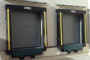 Two commercial loading dock doors with roll-up shutters and dock levelers installed by Devildog Dock N Door in Helena, MT.