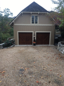 Two dark wood carriage-style garage doors installed by Advantage Door Company in Troy, MO.