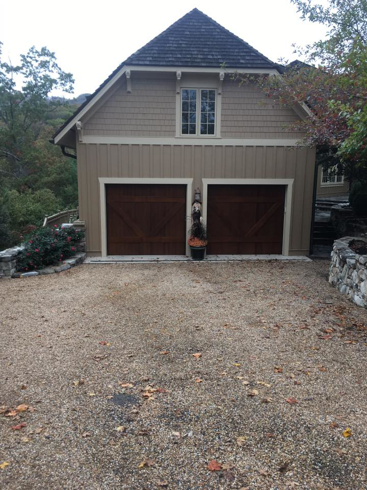 Two dark wood carriage-style garage doors installed by Advantage Door Company in Troy, MO.