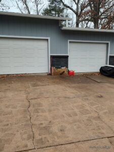 Two gray roll-up style commercial garage doors installed by Fayetteville Garage Door Co. in Fayetteville, AR