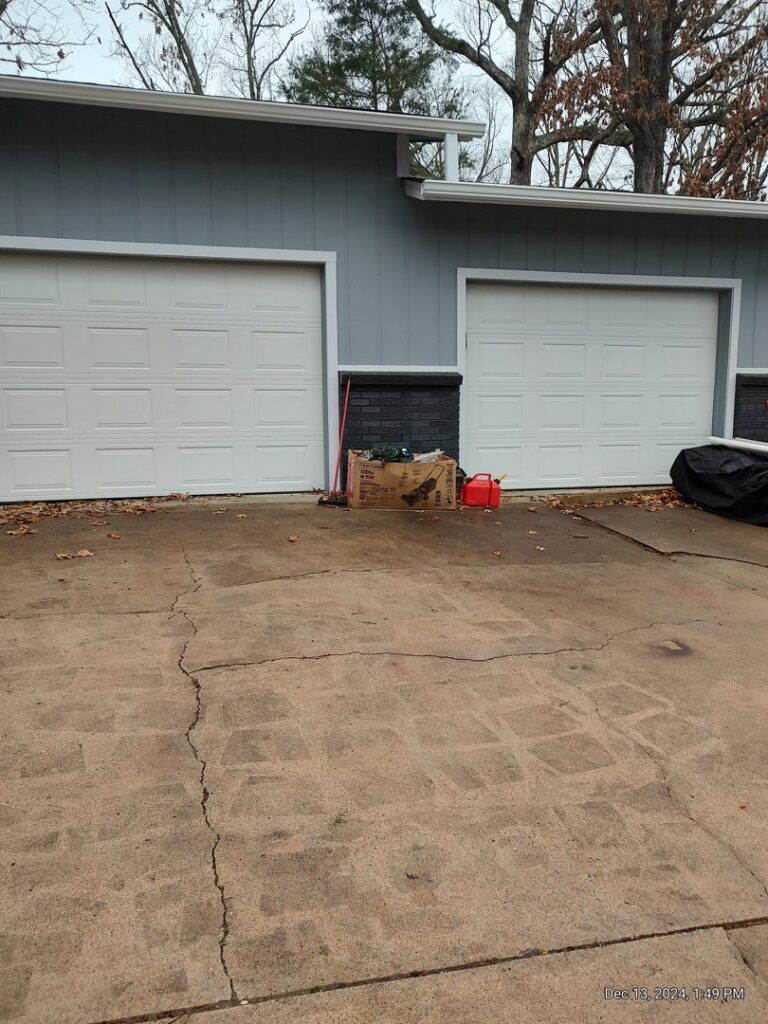 Two gray roll-up style commercial garage doors installed by Fayetteville Garage Door Co. in Fayetteville, AR