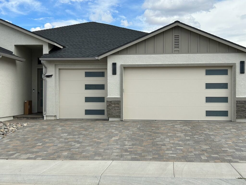 Two modern beige garage doors with horizontal windows, installed by Summit-Overhead-Door in Sparks, NV.
