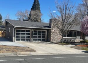 Two modern glass panel garage doors installed by Overhead Door of Sierra Nevada on a residential home in Reno, NV.