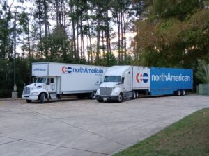 Two North American moving trucks parked, ready for service by Peroulas Moving and Storage in Knoxville, TN