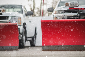 Two snow plow trucks ready for snow removal service by Eco Lawns in Ypsilanti, MI.