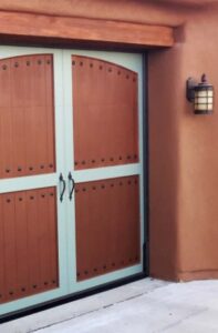 A unique two-tone garage door with decorative studs and handles, installed by Mark's Garage Door Services in Santa Fe, NM.