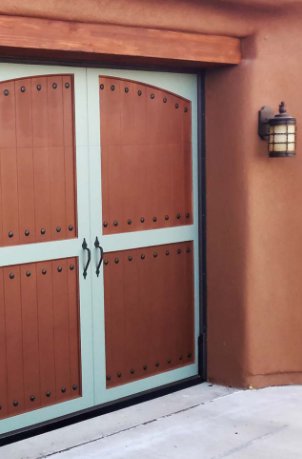 A unique two-tone garage door with decorative studs and handles, installed by Mark's Garage Door Services in Santa Fe, NM.