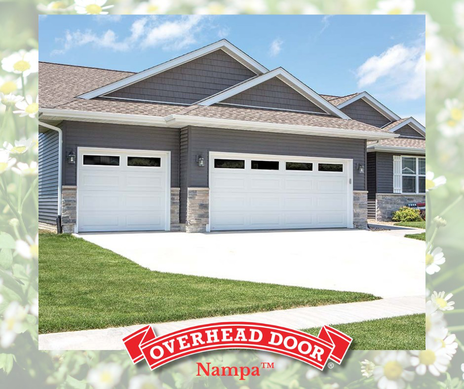 Two white garage doors installed on a modern residential home by Overhead Door Company of Nampa in Nampa, ID.