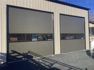Two white panel residential garage doors installed by Fayetteville Garage Door Co. in Fayetteville, AR
