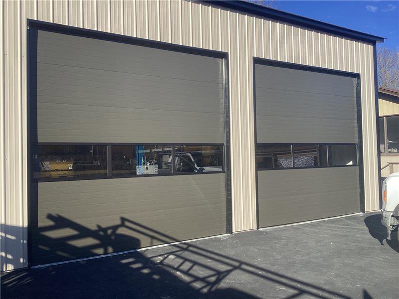Two white panel residential garage doors installed by Fayetteville Garage Door Co. in Fayetteville, AR