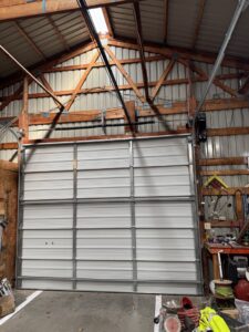 Two elegant wooden-look garage doors installed on a residential home by Summit Garage Door in Overland Park, KS.