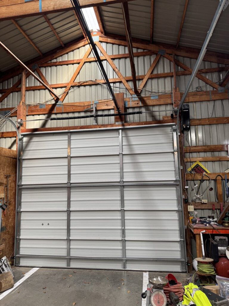 Two elegant wooden-look garage doors installed on a residential home by Summit Garage Door in Overland Park, KS.