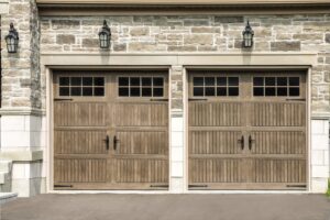 Two wooden-style garage doors with decorative hardware and windows by Access Door Systems in Uniontown, PA.