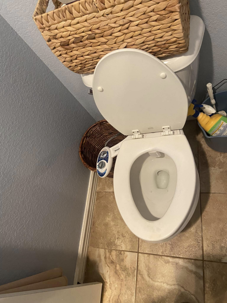 An unclean toilet and bathroom floor, highlighting the need for professional house cleaning from Cleaning with Care in Fayetteville, AR.