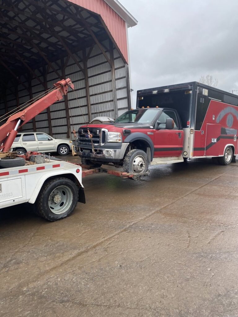 A utility truck being towed by RonniesTowing&Recovery in Bryan, TX