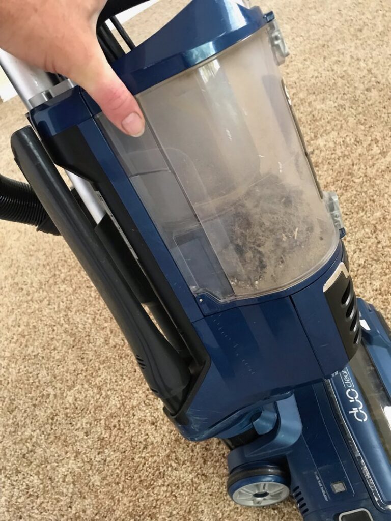 A vacuum cleaner with a full dustbin, demonstrating the amount of dirt removed by Blubyrd Cleaning Service in Boise, ID.