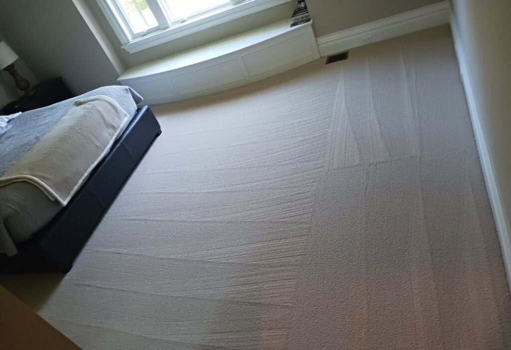 A freshly vacuumed carpet with distinct lines in a bedroom, showcasing the detailed work of Cascade Fresh Cleaning Services in Grand Rapids, MI.