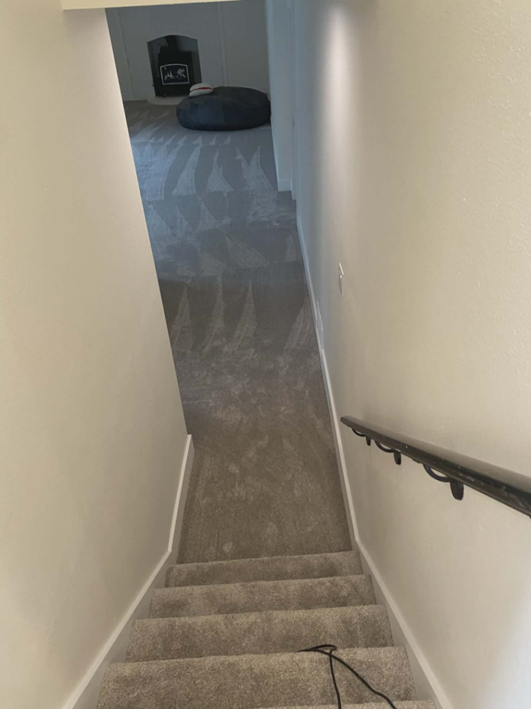 Clean carpeted stairs and hallway with vacuum lines, showing professional house cleaning by Best Kingdom Cleaning LLC in Spokane, WA.